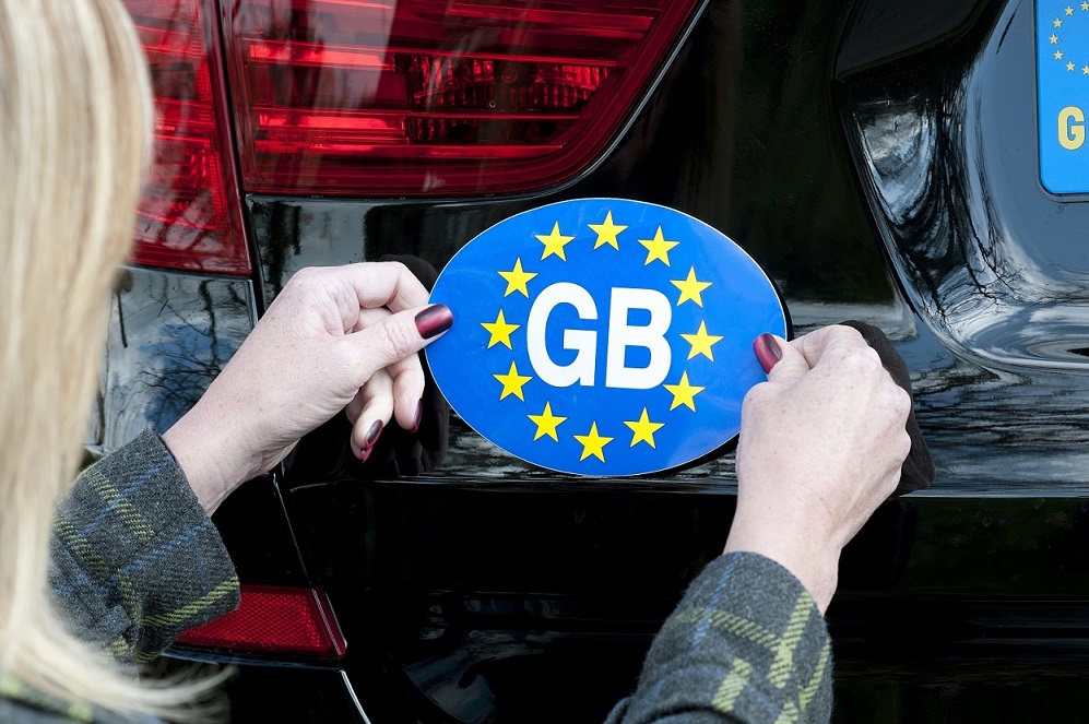 GB sticker being placed on car