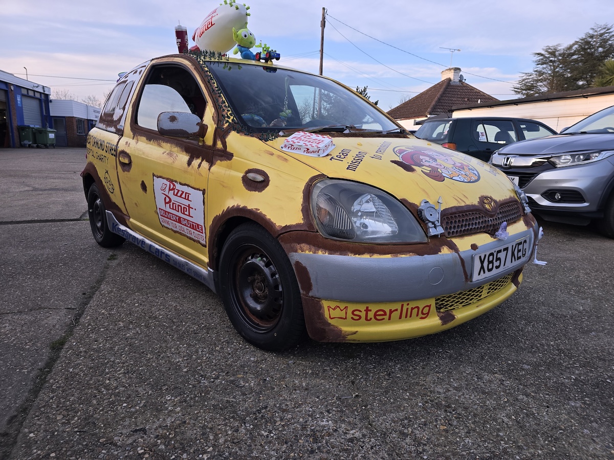 Image of a Toyota Yaris transformed into a Pizza Planet truck from Toy Story for a banger rally
