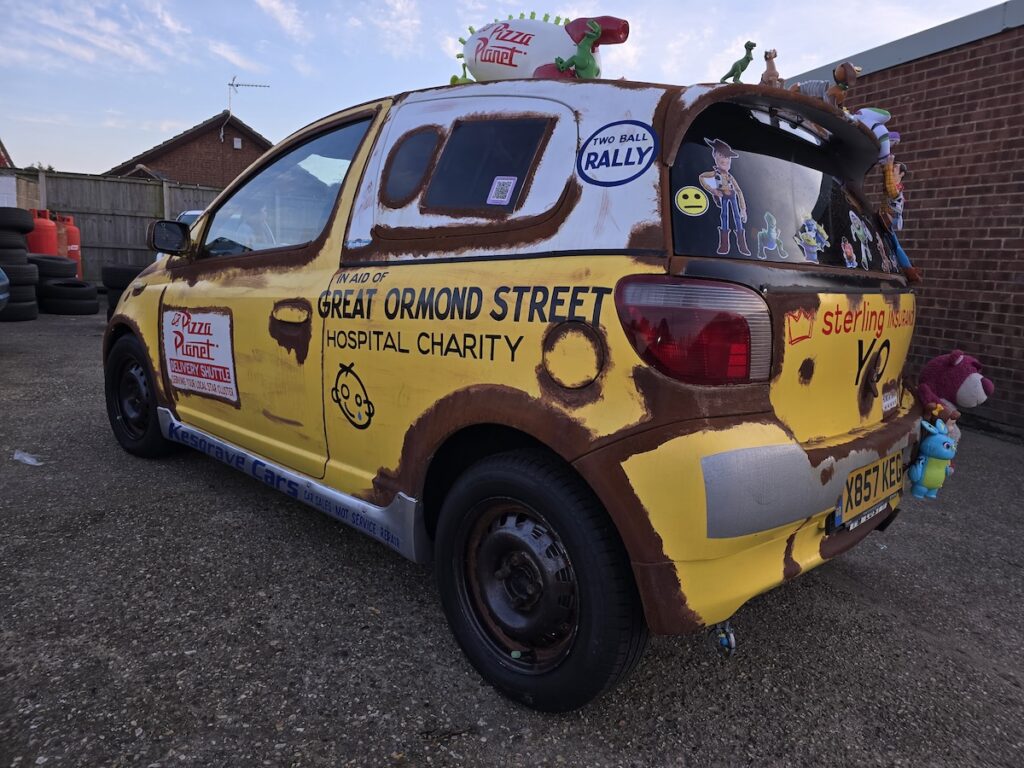 Image of a Toyota Yaris transformed into a Pizza Planet truck from Toy Story for a banger rally