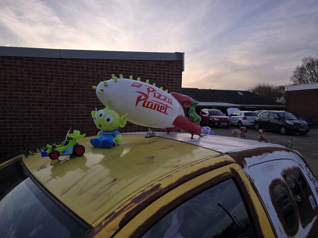 Image of a Toyota Yaris transformed into a Pizza Planet truck from Toy Story for a banger rally