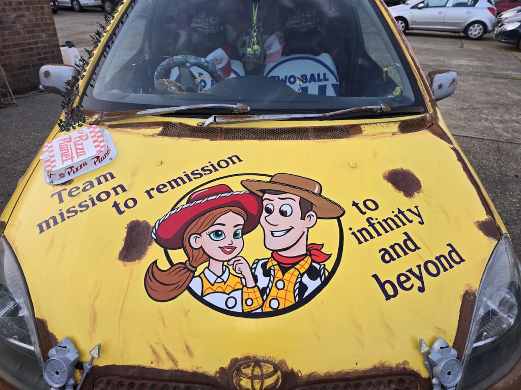Image of a Toyota Yaris transformed into a Pizza Planet truck from Toy Story for a banger rally