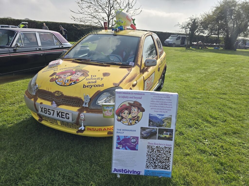 Image of a Toyota Yaris transformed into a Pizza Planet truck from Toy Story for a banger rally