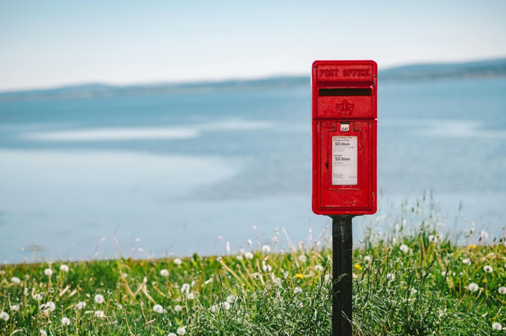 Red UK mailbox in rural area