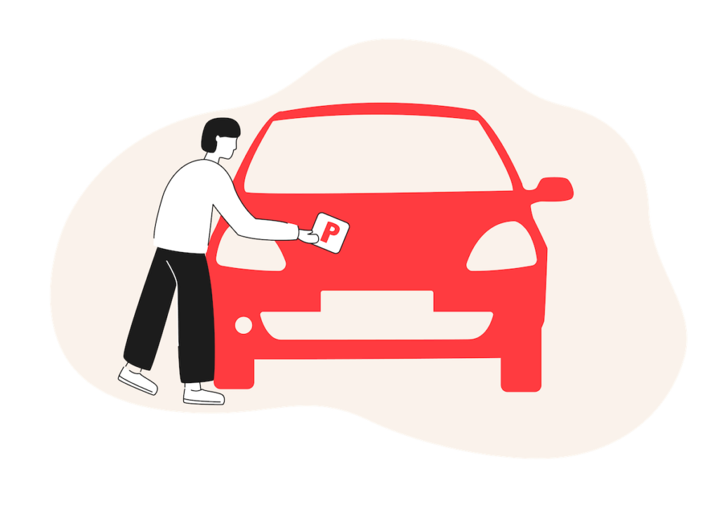 A young driver attaching a 'P' plate to the bonnet of their car - after passing my driving test