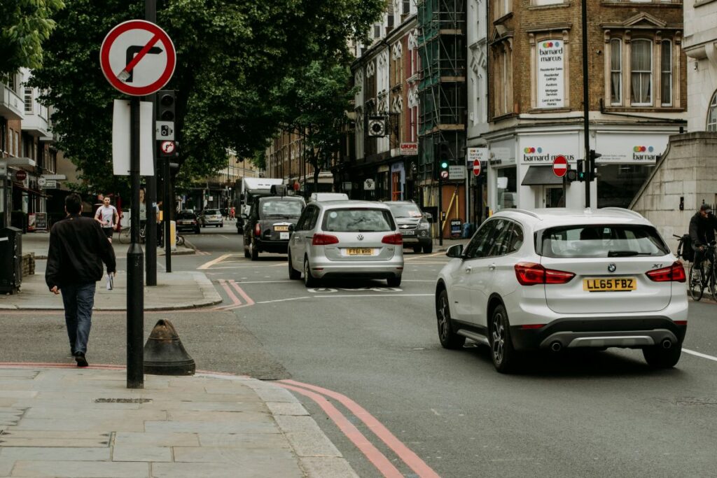 Cars and taxis driving down the road