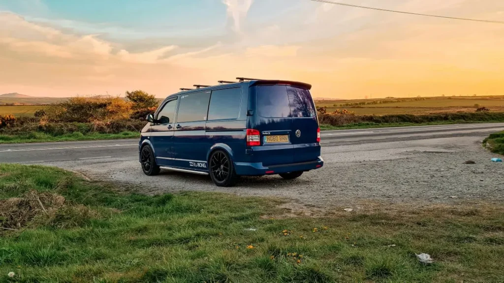 Converted van parked outside with the sunset in the background