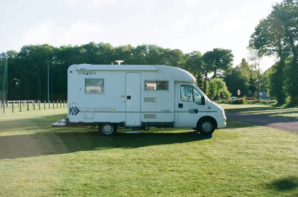 Motorhome parked outside on the grass in the sun