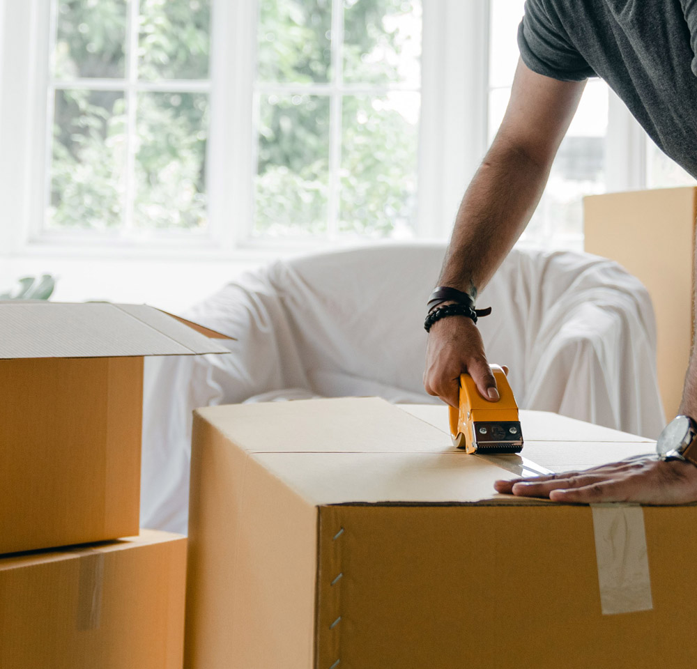 Man taping up packing box